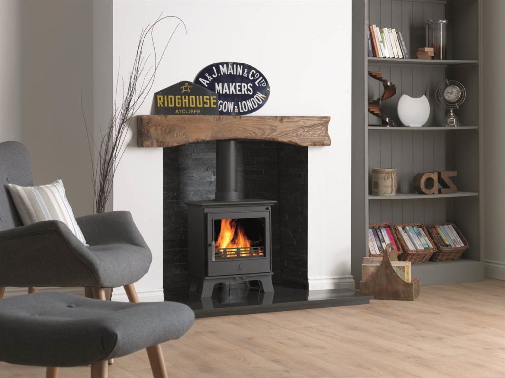 Black ACR wood burner stove in a white living room.